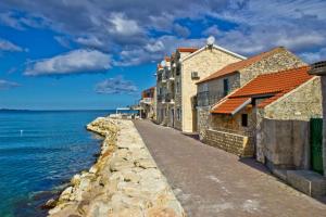a street with buildings next to the water at Apartment 877-3 in Bibinje