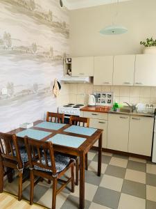 a kitchen with a dining room table and chairs at Happy Apartments in Poznań