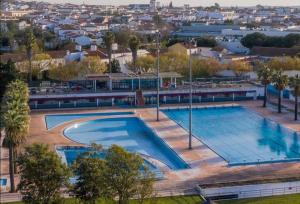 an overhead view of a swimming pool with a city at Casa Quintas in Reguengos de Monsaraz