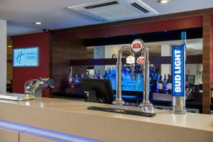 a counter top with a drink dispenser on top of it at Holiday Inn Express London - Dartford, an IHG Hotel in Dartford