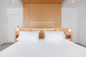 a bedroom with a large bed with two white pillows at Eurostars Marqués de Vallejo in Logroño