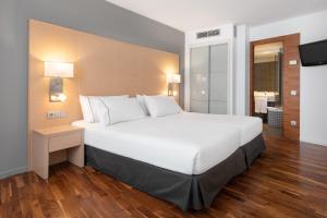 a large white bed in a hotel room at Eurostars Marqués de Vallejo in Logroño