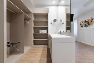a bathroom with a white sink and shelves at Eurostars Marqués de Vallejo in Logroño
