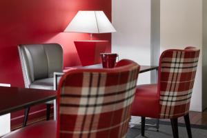 a room with two chairs and a table with a lamp at Eurostars Marqués de Vallejo in Logroño