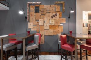 a restaurant with two tables and red chairs at Eurostars Marqués de Vallejo in Logroño