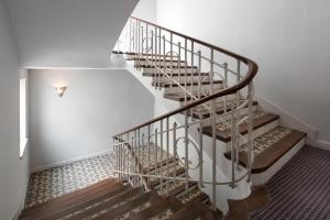 a spiral staircase in a home with white walls at Eurostars Marqués de Vallejo in Logroño