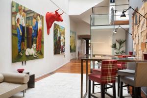a dining room with a large painting on the wall at Eurostars Marqués de Vallejo in Logroño
