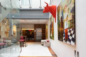 a hallway in a building with paintings on the walls at Eurostars Marqués de Vallejo in Logroño