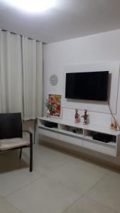 a living room with a flat screen tv on a wall at Sol e Mar Solar do Atlântico-Tambaú-João Pessoa in João Pessoa