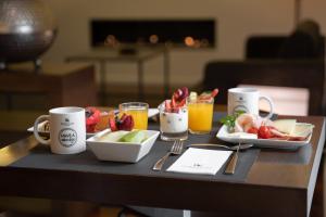 a table topped with plates of food and drinks at Eurostars Marqués de Vallejo in Logroño