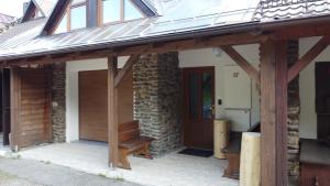 a house with a glass roof and a wooden door at Apartmány Kubova Huť in Kubova Huť