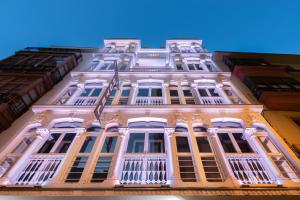 a tall white building with windows and balconies at Eurostars Marqués de Vallejo in Logroño