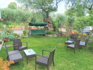 a group of chairs and tables in a yard at Tsafas Αpartments in Limenas +23 photos