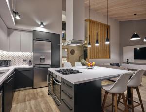 a kitchen with a counter and a stove top oven at Villa Belen in Kypseli