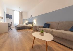 a living room with a couch and a table at Palazzo Lombardi Al Vicolo in Sassari