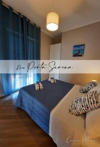 a bedroom with a bed with two pillows on it at B&B Casa Mare Paestum in Paestum