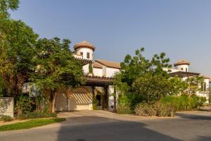 a large house with a driveway in front of it at Frank Porter - The Villa, Ponderosa in Dubai