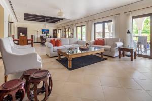 a living room with white couches and a coffee table at Frank Porter - The Villa, Ponderosa in Dubai