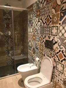a bathroom with a toilet and a shower and a sink at ALBERGO LOCANDA DIANA in Genoa