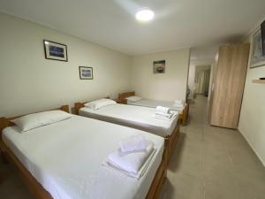 Postel nebo postele na pokoji v ubytování Totem Apartments