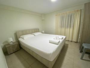 Postel nebo postele na pokoji v ubytování Totem Apartments