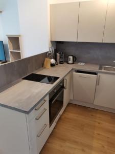 a kitchen with white counters and white cabinets at Ferienwohnung Thaya 