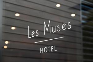a sign that says lesumes hotel on a window at Hôtel Les Muses in Annecy