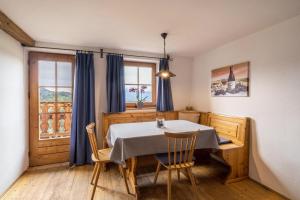 a dining room with a table and two chairs at Ferienwohnung Enzian Nusserhof in Avelengo