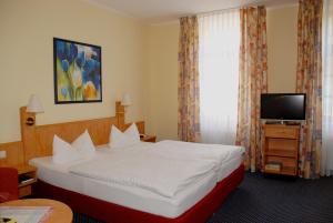 Postel nebo postele na pokoji v ubytování Hotel Alte Schule