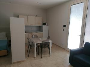 a kitchen and dining room with a table and chairs at Zibibbo Beach Apartments - Trapani in Trapani