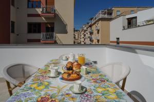 a table with a plate of food on a balcony at A I R Il Palazzetto in Vico Equense
