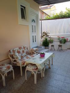 a patio with a couch and a table and chairs at R&S Apartments in Herceg-Novi