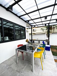 a patio with a glass table and chairs at Ban Rub Lom Pool Villa 3 difference villas in Rayong