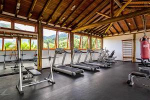 a gym with a row of exercise bikes in a room at Maresias Beach House - Casas de alugueis em cond beira mar in Maresias