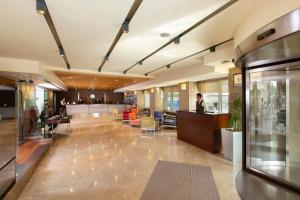 a lobby of a building with tables and chairs at Nippon Hotel in Istanbul