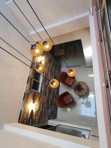 a room with a staircase with some chairs and lights at HOTEL SANTORI in Pasto