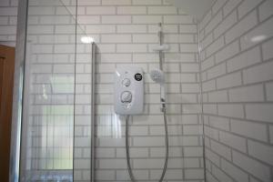 a shower in a bathroom with a shower at Risca Retreat in Risca