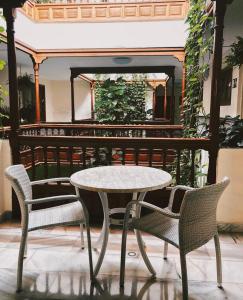 a table and two chairs and a table and chairs at Apartamentos Tapahuga in Playa de Santiago