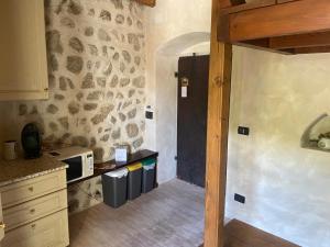 a kitchen with a counter with a microwave in it at La Columbera in Trento