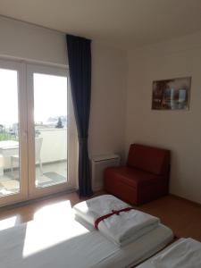Giường trong phòng chung tại Hotel Lukas