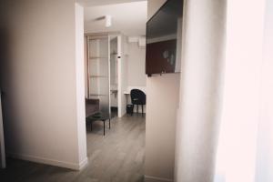 a hallway with a table and a dining room at Best Western Plus La Corniche in Toulon