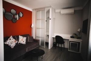 a living room with a couch and a table at Best Western Plus La Corniche in Toulon