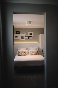 a bedroom with a large bed with two pillows at Best Western Plus La Corniche in Toulon