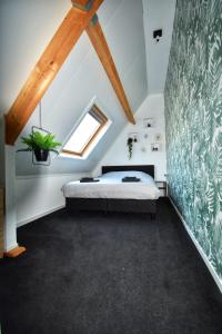 a bedroom with a bed in a attic at 't zeeuwse achteruusje in Sint Annaland