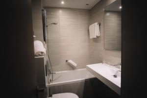 a bathroom with a shower and a sink and a toilet at Best Western Plus La Corniche in Toulon