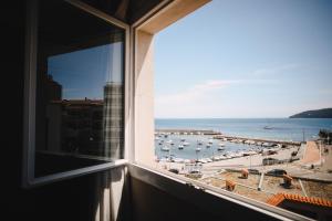 a window with a view of a marina at Best Western Plus La Corniche in Toulon