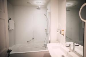 a bathroom with a shower and a sink and a tub at Best Western Plus La Corniche in Toulon