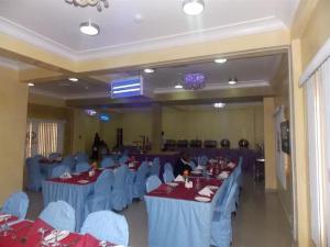 a banquet hall with blue tables and blue chairs at Ayalla Hotels now Elomas Hotel-Royal in Abuja +28 photos