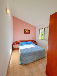 Säng eller sängar i ett rum på Villaggio Mare Blu