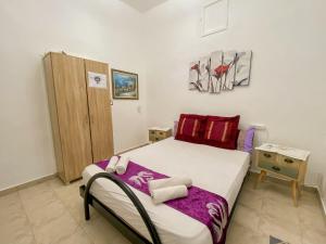 a small bedroom with a bed and a wooden cabinet at Old Town Guest House in Beer Sheva